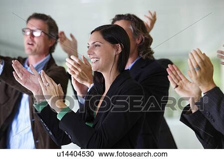 Stock Image - Business team applauding, smiling. Fotosearch