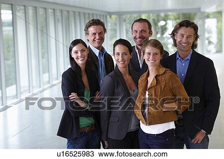 Business team smiling in empty office View Large Photo Image Stock Image - Business team smiling in empty office. Fotosearch
