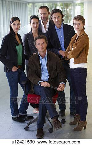 Stock Image - Business team standing beside the boss. Fotosearch