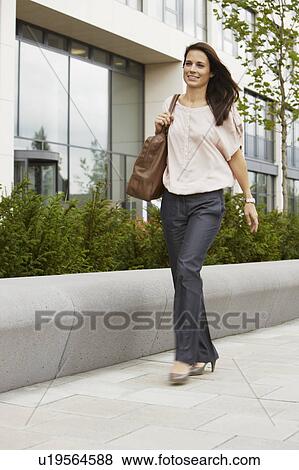 Stock Photo - Business Woman walking on boardwalk. Fotosearch