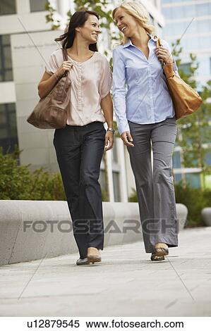 Business women having fun on sidewalk View Large Photo Image Stock Photography - Business women having fun on sidewalk. Fotosearch