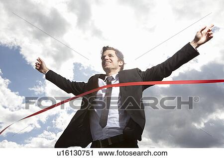 Businessman crossing finish line View Large Photo Image Stock Image - Businessman crossing finish line. Fotosearch