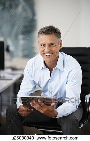 Businessman holding clipboard View Large Photo Image Stock Image - Businessman holding clipboard. Fotosearch