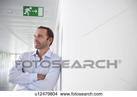 Businessman in an empty office View Large Photo Image Picture - Businessman in an empty office. Fotosearch