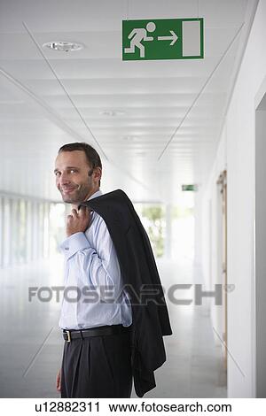 Businessman in an empty office, smiling View Large Photo Image Stock Image - Businessman in an empty office, smiling. Fotosearch