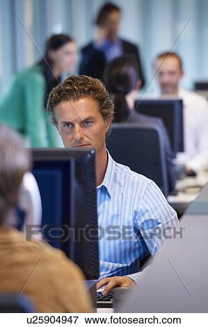 Stock Photo - Businessman in office, working. Fotosearch