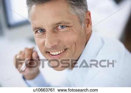 Businessman looking up to camera View Large Photo Image Stock Image - Businessman looking up to camera. Fotosearch