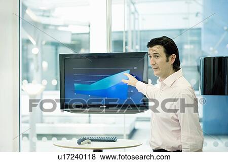 Businessman pointing at presentation View Large Photo Image Stock Photo - Businessman pointing at presentation. Fotosearch