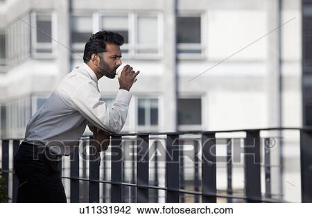 Businessman thinking and drinking coffee View Large Photo Image Stock Image - Businessman thinking and drinking coffee. Fotosearch