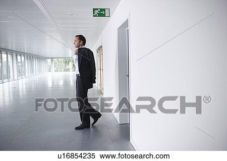 Stock Photography - Businessman walking into an empty office. Fotosearch