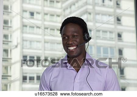 Businessman wearing phone headset View Large Photo Image Stock Photo - Businessman wearing phone headset. Fotosearch