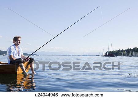 Stock Photograph - Businessman with fishing rod in rowboat. Fotosearch