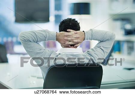 Picture - Businessman with hands behind head. Fotosearch
