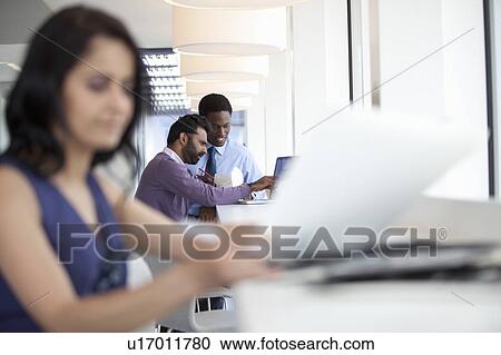 Businessmen using laptop and eating View Large Photo Image Stock Image - Businessmen using laptop and eating. Fotosearch