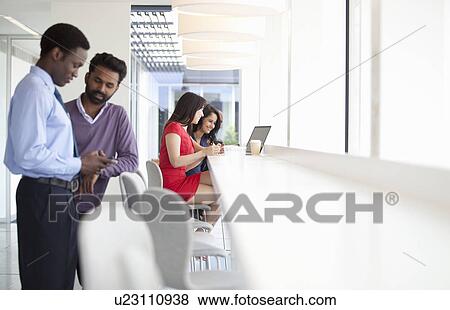 Businesspeople using mobile technology View Large Photo Image Stock Photo - Businesspeople using mobile technology. Fotosearch