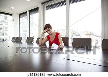 Businesswoman looking at letter View Large Photo Image Stock Photo - Businesswoman looking at letter. Fotosearch