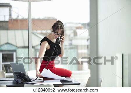 Stock Image - Businesswoman on telephone. Fotosearch