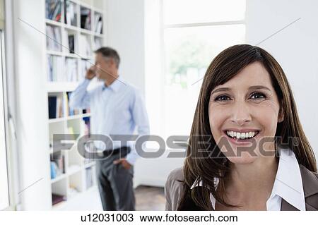 Stock Image - Businesswoman smiling to camera. Fotosearch