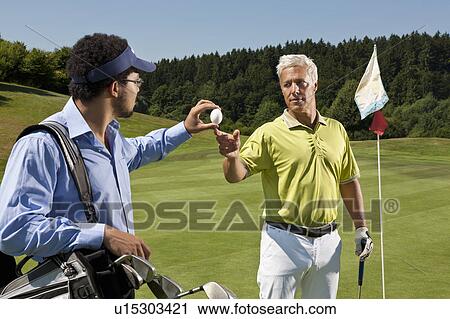 Caddy gives an egg to another golfer View Large Photo Image Stock Image - Caddy gives an egg to another golfer. Fotosearch