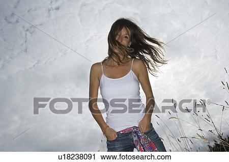 Stock Image - Carefree female looking into camera. Fotosearch