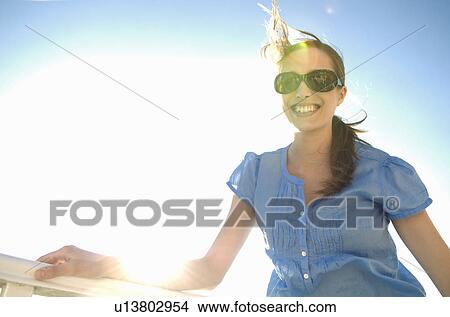 Chic woman in sunlight looks to camera View Large Photo Image Picture - Chic woman in sunlight looks to camera. Fotosearch