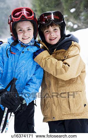 Stock Image - Children on skis hugging. Fotosearch