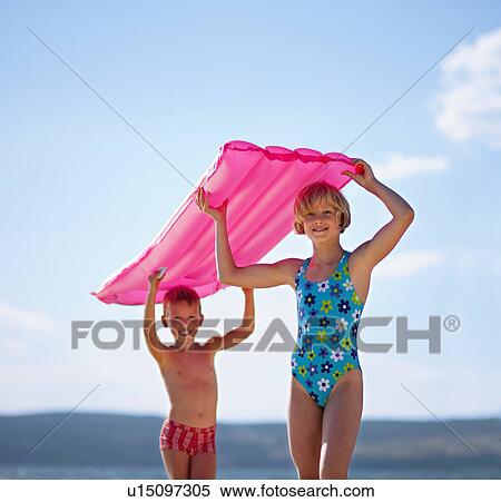 Children with inflatable at the beach View Large Photo Image Stock Photography - Children with inflatable at the beach. Fotosearch