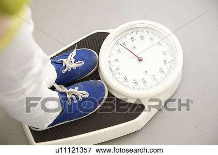 Child's feet on scales View Large Photo Image Stock Photo - Child's feet on scales. Fotosearch