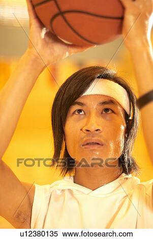 Stock Photography - Chinese basketball player aiming. Fotosearch