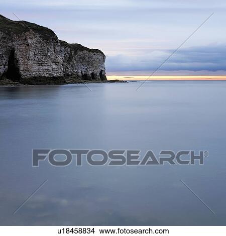 Cliffs by sea at sunset View Large Photo Image Picture - Cliffs by sea at sunset. Fotosearch