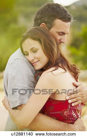 Close-up of couple embracing View Large Photo Image Stock Image - Close-up of couple embracing. Fotosearch