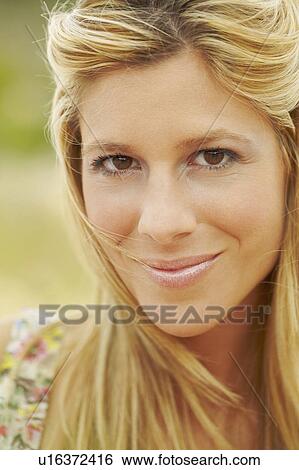 Stock Photograph - Close-up portrait of smiling young woman. Fotosearch