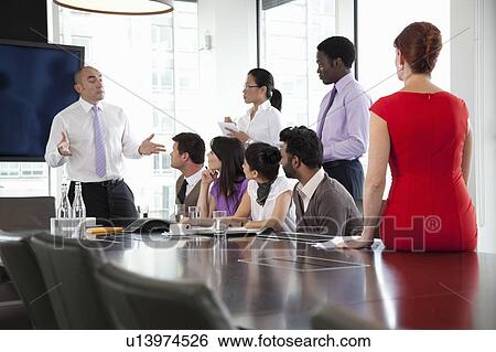 Colleagues listening to businessman View Large Photo Image Stock Photograph - Colleagues listening to businessman. Fotosearch