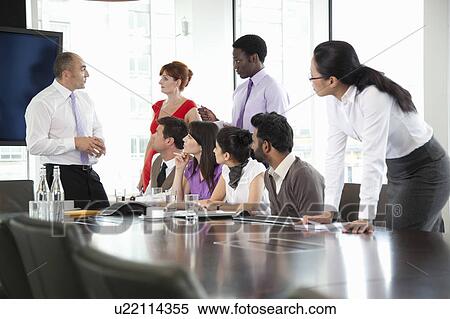 Colleagues listening to businessman View Large Photo Image Stock Photography - Colleagues listening to businessman. Fotosearch