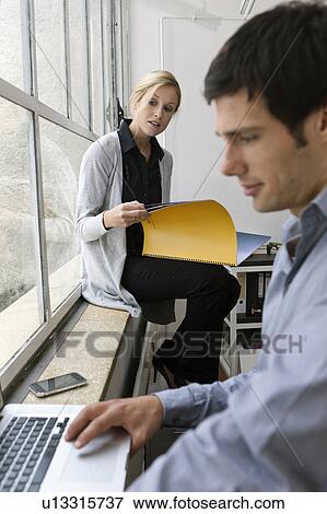 Colleagues preparing for a meeting View Large Photo Image Stock Photo - Colleagues preparing for a meeting. Fotosearch