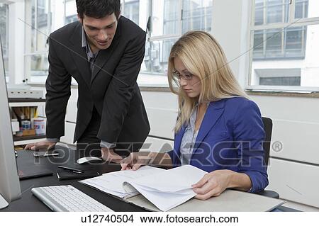 Colleagues reviewing a business plan View Large Photo Image Picture - Colleagues reviewing a business plan. Fotosearch