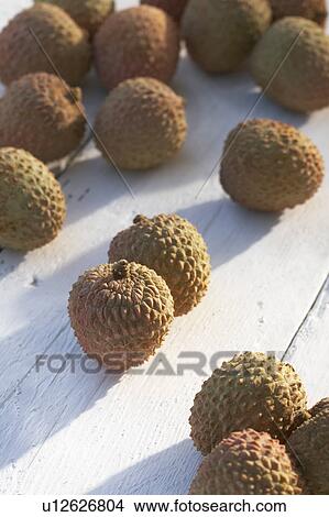 Picture - Collection of lychees on sunny table. Fotosearch