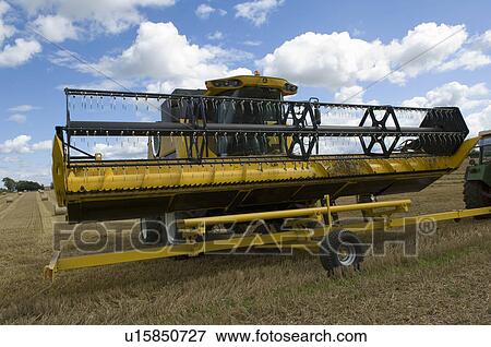 Combine harvester unloading header View Large Photo Image Stock Photo - Combine harvester unloading header. Fotosearch