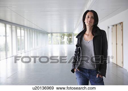 Confident woman in empty office View Large Photo Image Stock Photo - Confident woman in empty office. Fotosearch