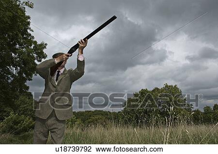 Stock Image - Country man with shot gun. Fotosearch
