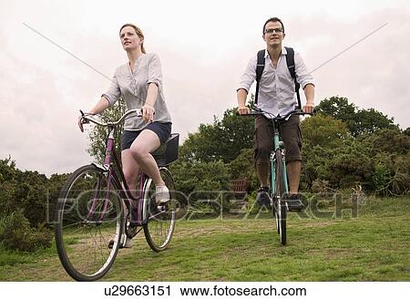 Couple bicycle over heath View Large Photo Image Stock Image - Couple bicycle over heath. Fotosearch