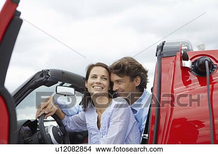 Couple close together in an electric car View Large Photo Image Picture - Couple close together in an electric car. Fotosearch