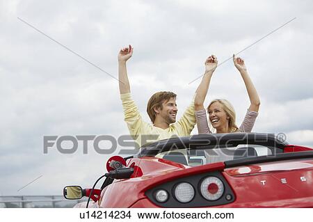Couple close together in an electric car View Large Photo Image Picture - Couple close together in an electric car. Fotosearch