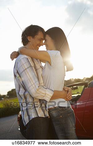 Couple close/hugging during sunset View Large Photo Image Stock Photo - Couple close/hugging during sunset. Fotosearch