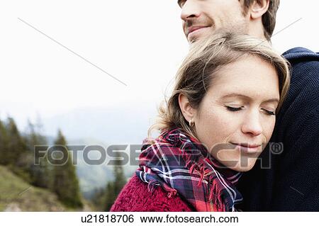 Couple cuddling View Large Photo Image Stock Photograph - Couple cuddling. Fotosearch