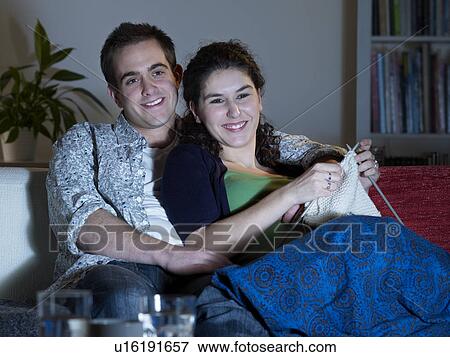Couple cuddling watching television View Large Photo Image Stock Photo - Couple cuddling watching television. Fotosearch