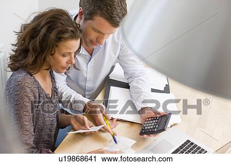 Couple doing account stuff View Large Photo Image Stock Image - Couple doing account stuff. Fotosearch