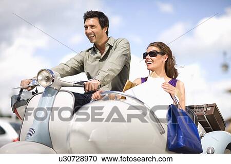 Couple driving a vespa View Large Photo Image Stock Image - Couple driving a vespa. Fotosearch