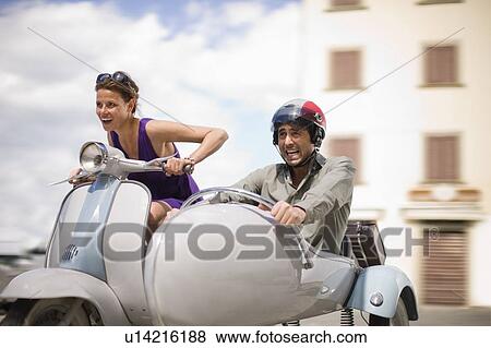 Stock Photo - Couple driving a vespa. Fotosearch
