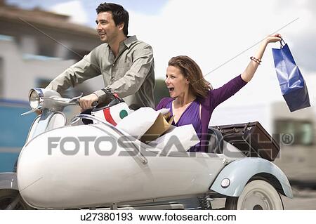 Stock Image - Couple driving home from shopping. Fotosearch